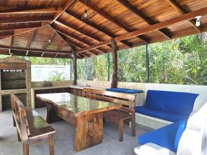 a patio with a wooden table and a blue couch at Nosara Paradise Rentals in Nosara