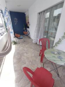 a room with a table and red chairs and a table and a table and chairs at Sunset In Malabrigo in Puerto Chicama
