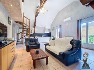 a living room with a couch and a table at Le Gite Cazette in Ance