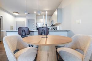 a dining room with a wooden table and chairs at Warm, Inviting 2BD Apt In Matthews in Charlotte +16 photos