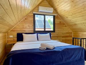 a bedroom with a bed in a wooden cabin at Les Pavillons D'Ehden in Ehden +45 photos