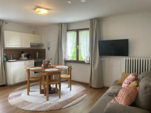 a living room with a couch and a table at Gästehaus Sandvoss in Titisee-Neustadt