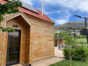 a small wooden building with a glass door at Les Pavillons D'Ehden in Ehden