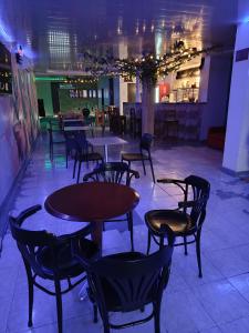a restaurant with tables and chairs in a room at Hostal Cigarra in Panama City