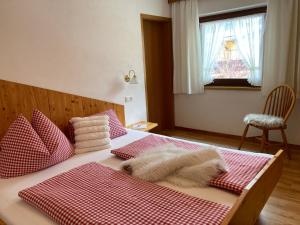a bedroom with a bed with red and white checkered sheets at Haus Hoher Sattel in Leutasch