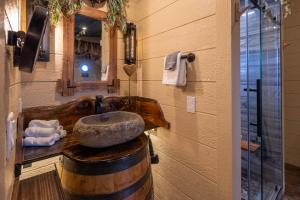 a bathroom with a sink in a wooden barrel at "Tree-T-Ment Center" Spa-Themed Luxury Treehouse with Indoor & Outdoor Soaking Tubs in Sevierville +37 photos