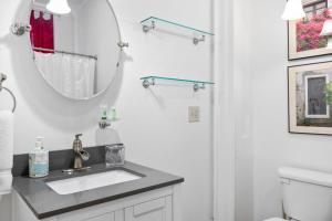 a bathroom with a sink and a mirror at Spacious Studio on Historic Inn Property in Asheville