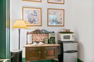 a small kitchen with a microwave and a refrigerator at Spacious Studio on Historic Inn Property in Asheville