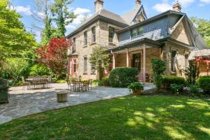 an old house with a patio and lawn at Spacious Studio on Historic Inn Property in Asheville
