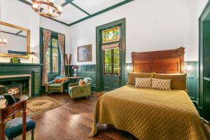 a bedroom with a bed and a fireplace at Spacious Studio on Historic Inn Property in Asheville +13 photos