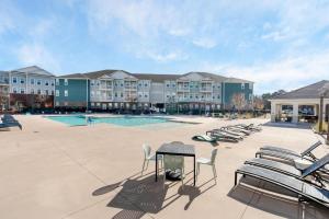 a courtyard with chairs and a swimming pool at Super Central 1BD Workers Paradise in Charlotte