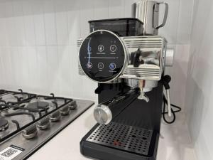 a mixer sitting on a counter next to a stove at Spacious New Home for 12 Guests in Campbelltown South