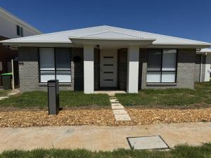 a house with a mailbox in front of it at Spacious New Home for 12 Guests in Campbelltown South