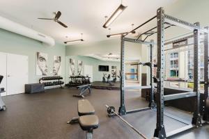 a gym with treadmills and exercise equipment in a building at Stylish, Comfortable 2BD Abode near DT Matthews in Charlotte