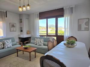 a living room with a large table and a couch at Apartamento La Hojarada 20809 in Argoños