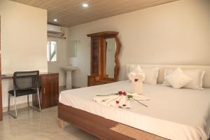 a bedroom with a bed with a flower on it at Raj Garden Resort in Guwahati