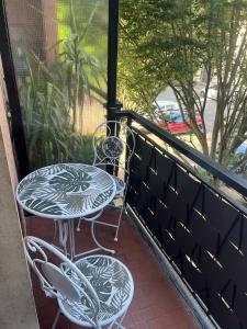 a patio with a table and chairs on a balcony at Relax suite in Alessandria