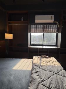 a bedroom with a bed in front of a window at Terrace By Opal in Barābhīta