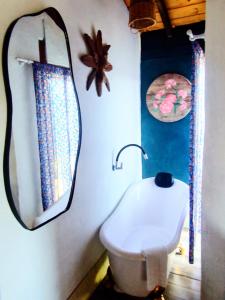 a bathroom with a mirror and a white sink at Na'raucária in Cambará +37 photos