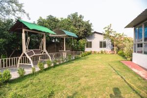 a backyard with a swing set and a house at Raj Garden Resort in Guwahati