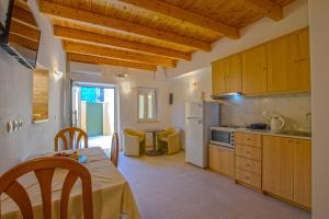 a kitchen with a table and a dining room at Corfu Spanos House in Sokraki in Sokrákion