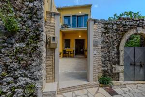 an external entrance to a house with a stone wall at Corfu Spanos House in Sokraki in Sokrákion
