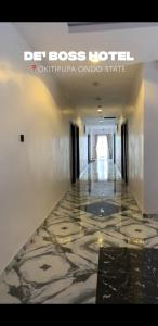 a hallway with a marble floor in a hotel at DE'BOSS hotels and suites in Okitipupa