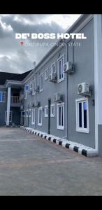 a building with a lot of windows on the side of it at DE'BOSS hotels and suites in Okitipupa