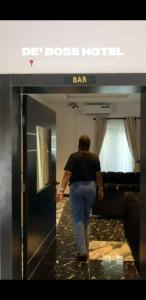 a man walking into a bar in a room at DE'BOSS hotels and suites in Okitipupa