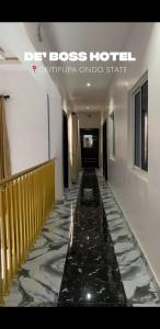 a hallway of a hotel with a marble floor at DE'BOSS hotels and suites in Okitipupa