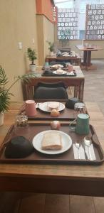 a table with plates of food on a tray at Soul Hostel Av Paulista Bela Vista 2 in São Paulo