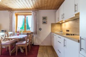 eine Küche und ein Esszimmer mit einem Tisch und Stühlen in der Unterkunft Landhaus Berktold in Obermaiselstein