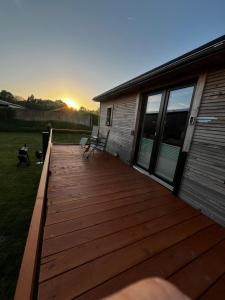 a large wooden deck next to a house at Tinyhaus auf dem Forsthof in Trinwillershagen