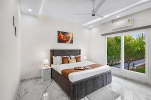 a bedroom with a large bed and a window at Luxury Haven Stay in Noida +42 photos