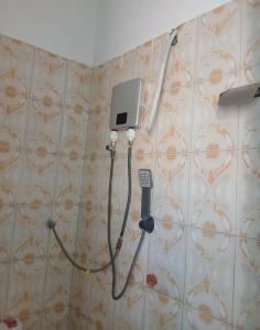 a room with a hair dryer and a wall at Amazing Grace Home - Oyugis studio in Oyugis