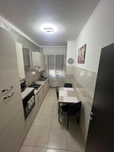 a kitchen with a table and a table and chairs at Relax suite in Alessandria