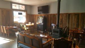 a living room with a fireplace and a television in it at The Bears Went Over The Mountain in Geeveston