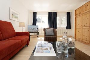 a living room with a couch and a table at Gut Staberhof Staberholz in Staberdorf