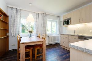 a kitchen with a table and a vase of flowers on it at Gut Staberhof Staberholz in Staberdorf