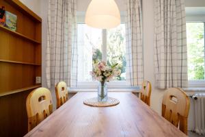 a vase of flowers sitting on a table in a room at Gut Staberhof Staberholz in Staberdorf +19 photos