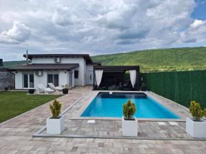 a swimming pool in the backyard of a house at Holiday Home Emma in Bihać