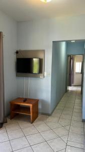 a room with a flat screen tv on a wall at Pousada Village in Florianópolis