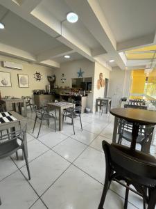 a restaurant with tables and chairs in a room at Pousada Village in Florianópolis