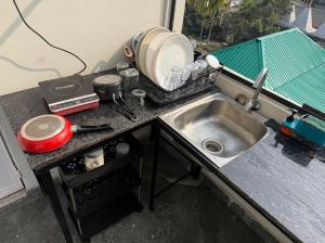 a kitchen counter top with a sink and a counter top at Terrace By Opal in Barābhīta
