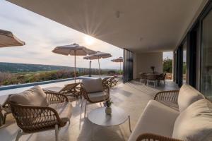 an outdoor living room with a view of the ocean at Villa Carbonia in Kolan