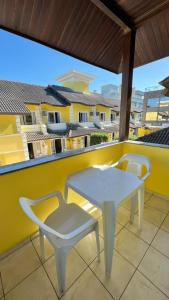 a white table and chairs on a balcony at Pousada Village in Florianópolis
