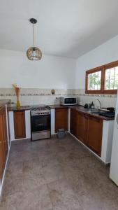 a kitchen with wooden cabinets and a stove at Hotel Cafayate in Cafayate