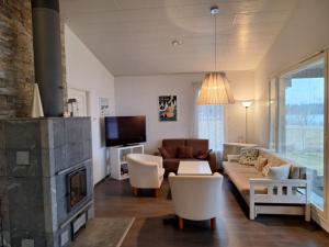 a living room with a couch and a fireplace at Paris Beach in Saarijärvi +13 photos