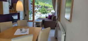 a living room with a table and a couch at Aparthotel Bergkristall in Brand