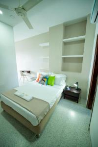 a bedroom with a large bed and a table at Hotel Tropical in Corozal